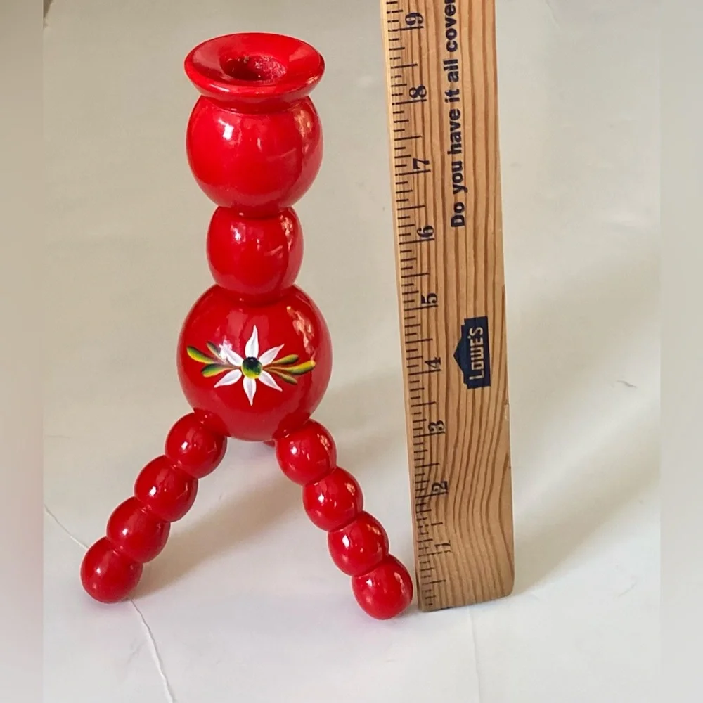 Vintage Swedish folk art wooden candle holder with a hand-painted daisy motif.